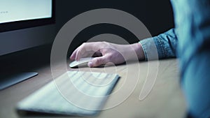 Male hand using wireless mouse and computer