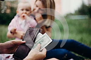 Male hand with wallet and US dollar bills