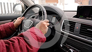 Male hand on wheel of car