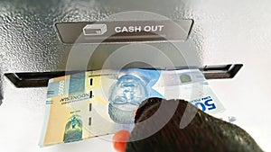 male hand withdrawing cash