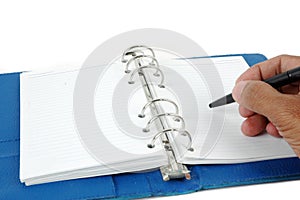 Male hand writing at blue leather notebook