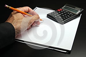 Male hand writing on a notepad