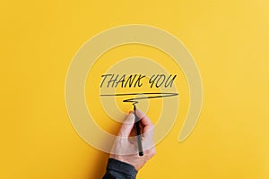 Male hand writing a Thank you sign