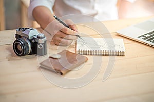 Male hand writing world outline on notebook