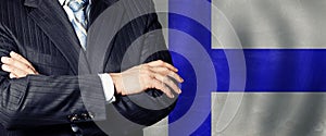 Male hands against Finnish flag background, business, politics and education in Finland concept