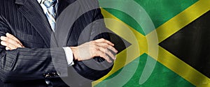 Male hands against Jamaican flag background, business, politics and education in Jamaica concept