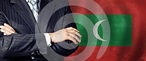 Male hands against Maldivian flag background, business, politics and education in Maldives concept