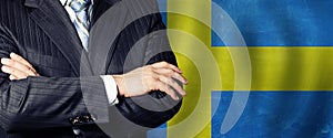 Male hands against Swedish flag background, business, politics and education in Sweden concept