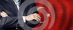 Male hands against Turkish flag background, business and politics in Turkey concept