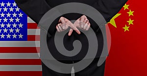 Male hands against USA and China flags background