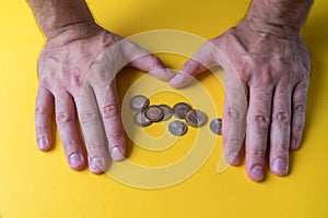 Male hands around coins. Protecting your money. Lack of money. Plan of expenses