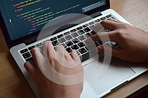 Male hands on a black keyboard. European coding on a computer. S