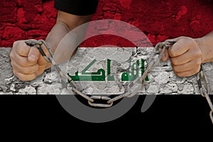 Male hands break the iron chain, a symbol of bondage,protest against the background of the national flag of Iraq, the concept of