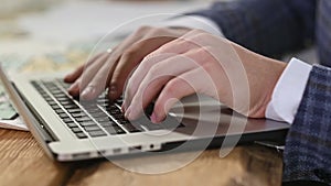 Male hands of business person type text on laptop keyboard.