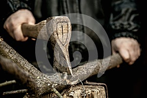 Male hands chopping firewood