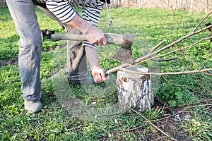 Male hands chopping firewood