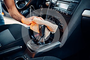 Male hands cleans car interior on carwash station photo