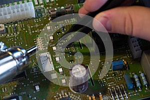 Male hands close up checking voltage on a microchip