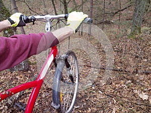 Male hands in cycling gloves, tightly holding the handlebars of