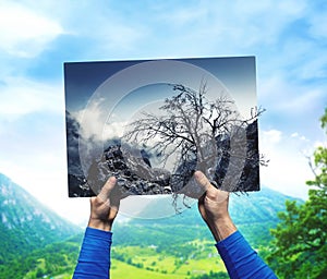 Male hands with dry, neglected nature landscape