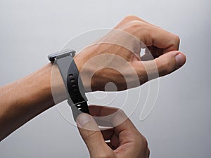 Male hands fastens the strap of smart watch.