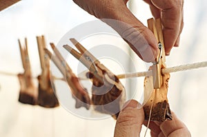 Male hands are hanging used tea bags for drying