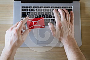 male hands hold credit card with laptop