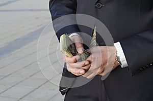 Businessman in a suit with a bundle of cash. financial capital.