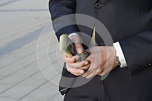 Male hands hold dollars banknotes. business concept. counting profits. money in hand.