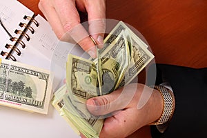 Male hands hold dollars