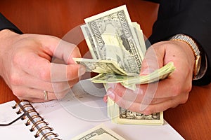 Male hands hold dollars