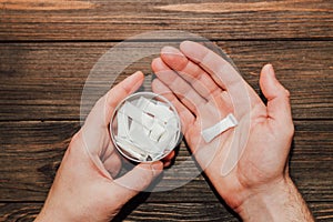 Male hands hold in hand a box of snus with nicotine spiders.