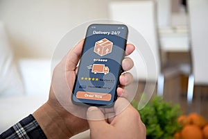 male hands hold phone with parcel delivery application on screen