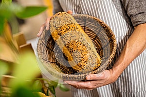 Male hands holding basket of bread