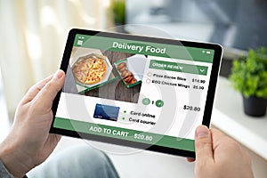 Male hands holding computer tablet with app delivery food