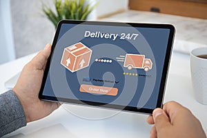 Male hands holding computer tablet with parcel delivery application