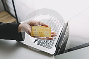 male hands holding a credit card and use mobile phone for Online payment online shopping