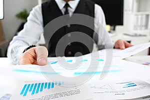 Male hands holding financial statistics documents searching for new opportunities
