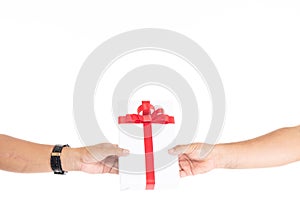 Male hands holding gift box wrapped with red ribbon isolated on white background with copy space. Man hand holding gift box giving