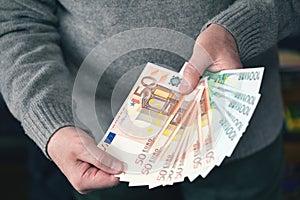 Male hands holding money in the form of a fan. Money, Euro currency