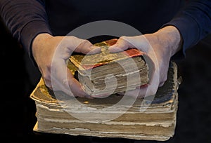 Male hands holding an old book