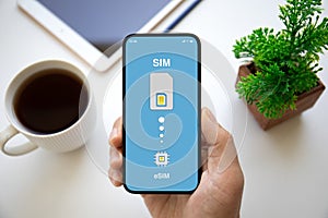 male hands holding phone with Sim card replacement on eSim