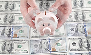 Male hands holding piggy bank on dollars background