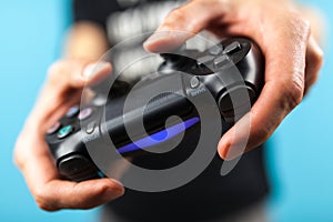 Male hands holding a PS4 controller