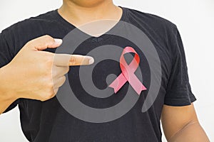 male hands holding red AIDS awareness ribbon.