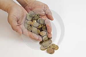 Male hands holding Russian iron coins close up on a white background. Russia crisis. small currency