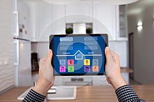 Male hands holding tablet with app smart home kitchen house