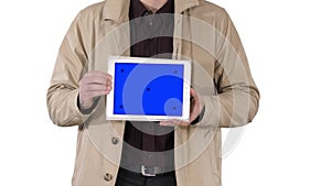 Male hands holding tablet with blue screen mockup on white background.