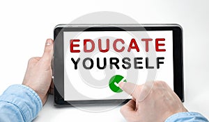 Male hands holding tablet pc with text EDUCATE YOURSELF