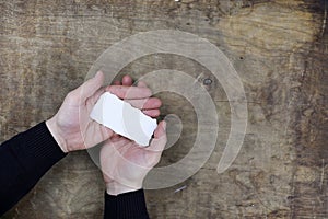 Male hands holding a white blank sheet of paper